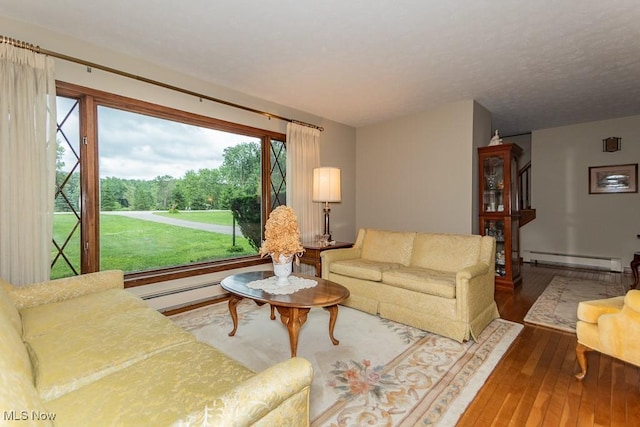 13228 Boulder, Chesterland, OH 44026 - living room with plenty of natural light, hardwood / wood-style floors, baseboard heating, and a baseboard heating unit