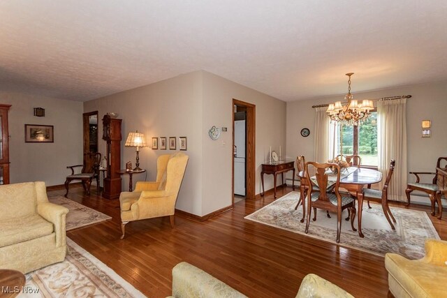 13228 Boulder, Chesterland, OH 44026 - living room featuring a chandelier, wood finished floors, and a baseboard radiator