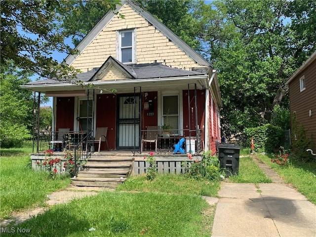 1227 E 112th St, Cleveland, OH 44108 - bungalow-style home featuring a porch and roof with shingles