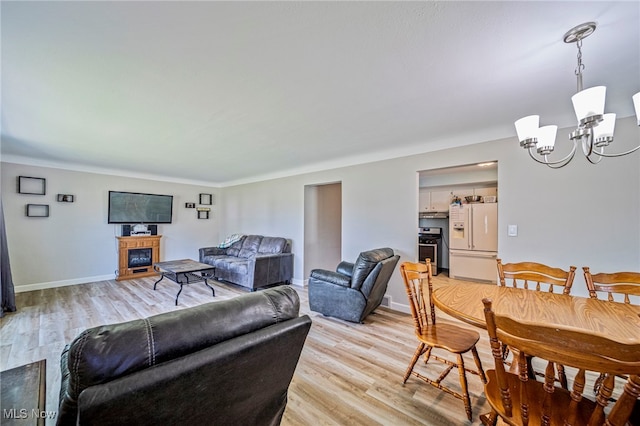 28666 Forest Rd, Willowick, OH 44095 - living room with light wood-type flooring and a chandelier