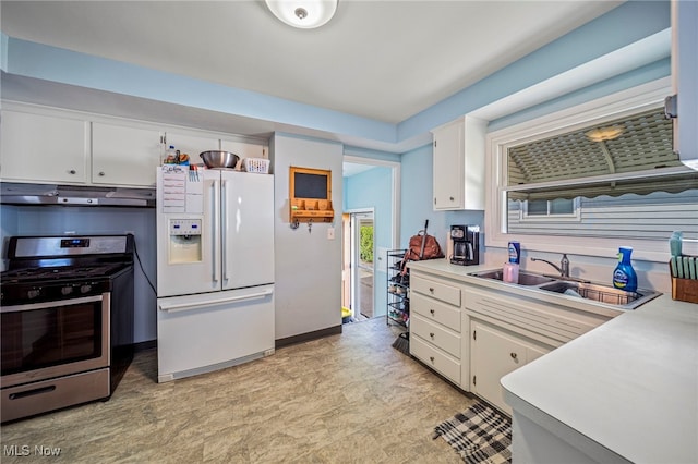 28666 Forest Rd, Willowick, OH 44095 - kitchen with white refrigerator with ice dispenser, stainless steel gas range oven, under cabinet range hood, white cabinetry, and light countertops