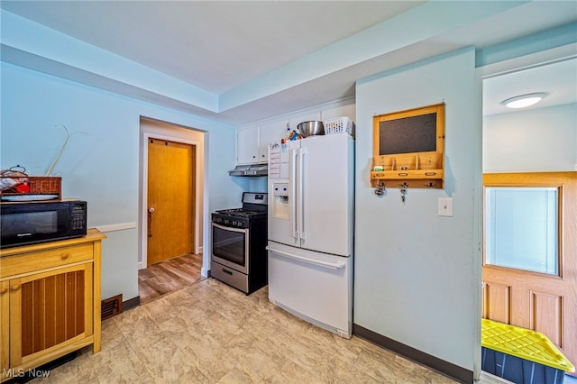 28666 Forest Rd, Willowick, OH 44095 - kitchen featuring white refrigerator with ice dispenser, stainless steel range with gas cooktop, black microwave, and under cabinet range hood