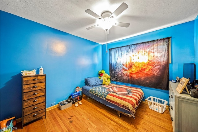 28666 Forest Rd, Willowick, OH 44095 - bedroom featuring a textured ceiling, wood finished floors, and ceiling fan