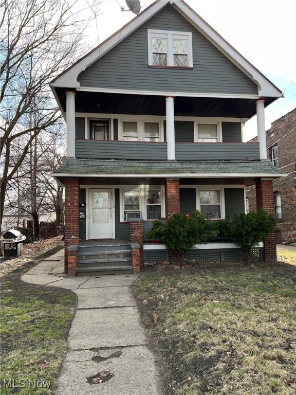 1114 E 64th St, Cleveland, OH 44103 - view of front of home with a porch, a balcony, and brick siding