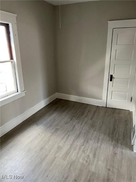 1114 E 64th St, Cleveland, OH 44103 - unfurnished room with wood finished floors and healthy amount of natural light