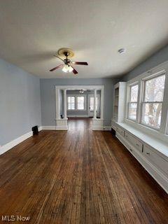 1114 E 64th St, Cleveland, OH 44103 - unfurnished living room with dark wood-style flooring and a ceiling fan