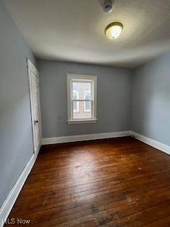 1114 E 64th St, Cleveland, OH 44103 - unfurnished room featuring hardwood / wood-style flooring and baseboards