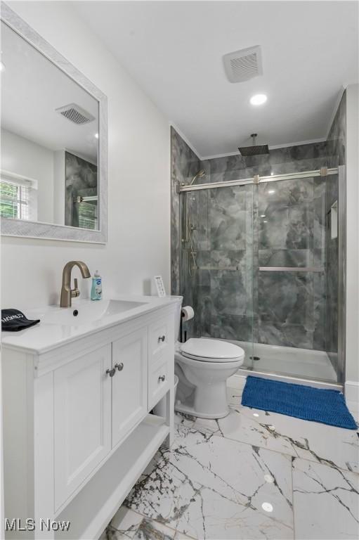 5111 N Myers Rd, Geneva, OH 44041 - bathroom featuring vanity, a marble finish shower, and marble look tiles