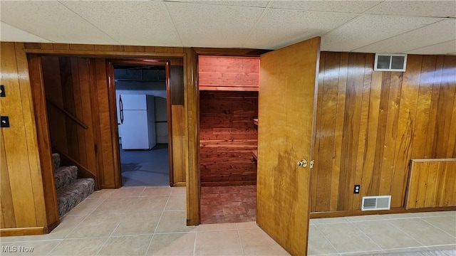 138 Marsha St, Weirton, WV 26062 - hallway with wood walls, tile patterned flooring, and stairway
