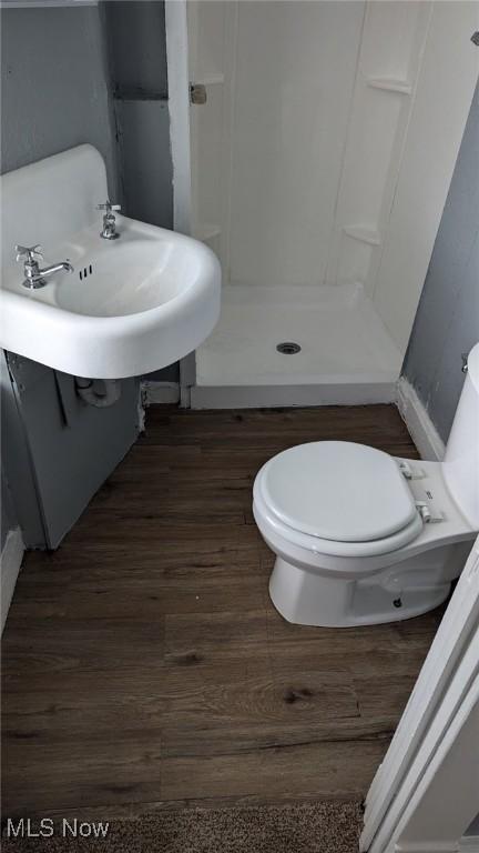 3821 E 55th St, Cleveland, OH 44105 - bathroom with wood finished floors and a shower stall