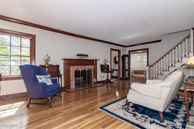 3336 Daleford Rd, Shaker Heights, OH 44120 - living room with wood finished floors, stairway, ornamental molding, and a high end fireplace