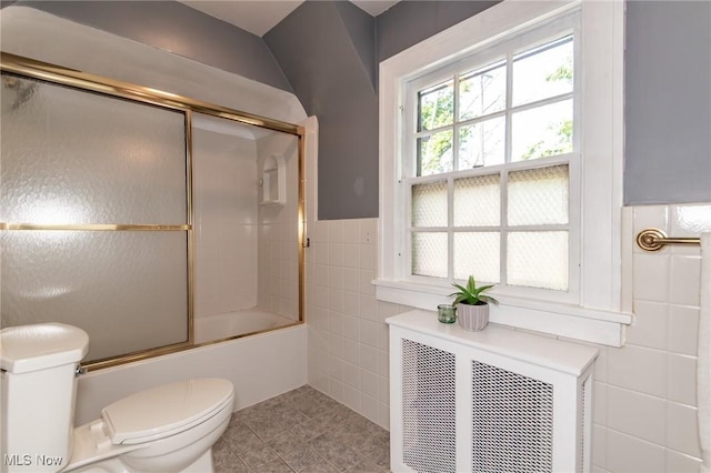3336 Daleford Rd, Shaker Heights, OH 44120 - bathroom featuring tile walls, tile patterned floors, enclosed tub / shower combo, and a wainscoted wall
