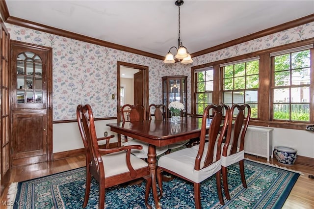 3336 Daleford Rd, Shaker Heights, OH 44120 - dining space featuring wallpapered walls, crown molding, wood finished floors, wainscoting, and a chandelier