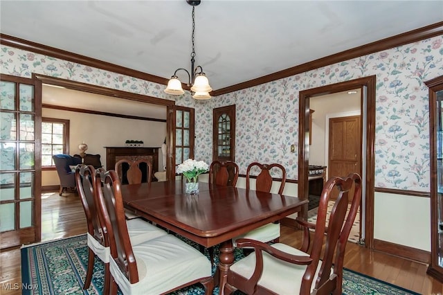 3336 Daleford Rd, Shaker Heights, OH 44120 - dining room with wallpapered walls, wood-type flooring, crown molding, and a chandelier