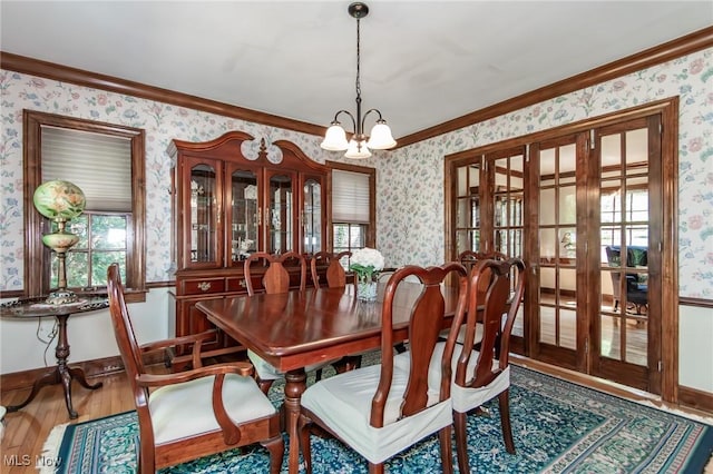 3336 Daleford Rd, Shaker Heights, OH 44120 - dining room with wallpapered walls, a chandelier, wood finished floors, ornamental molding, and french doors