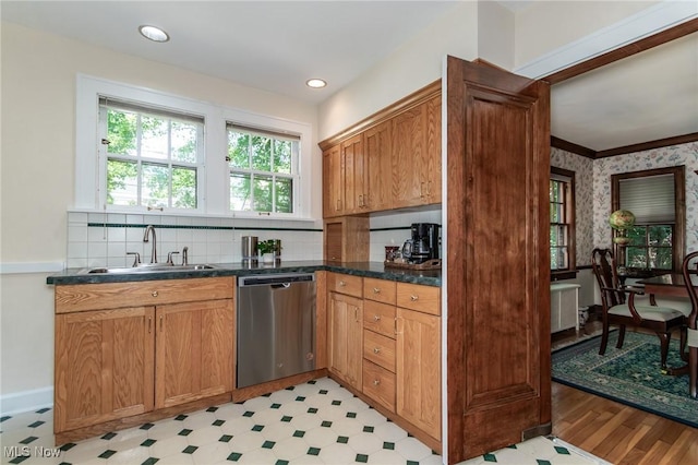 3336 Daleford Rd, Shaker Heights, OH 44120 - kitchen with stainless steel dishwasher, light floors, dark countertops, backsplash, and wallpapered walls