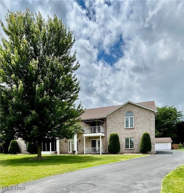930 Pearson Cir Unit 4, Youngstown, OH 44512 - view of front of home with a front lawn, an outbuilding, stone siding, and a detached garage