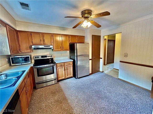 930 Pearson Cir Unit 4, Youngstown, OH 44512 - kitchen featuring appliances with stainless steel finishes, under cabinet range hood, brown cabinetry, light countertops, and ornamental molding