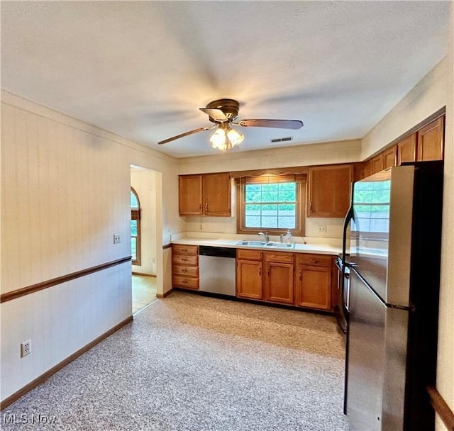 930 Pearson Cir Unit 4, Youngstown, OH 44512 - kitchen featuring stainless steel appliances, brown cabinetry, ceiling fan, and light countertops