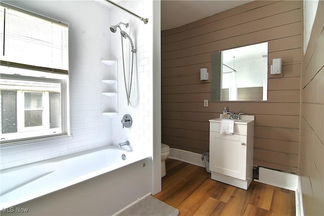 1134 Auburn Pl NW, Canton, OH 44703 - full bathroom with wood walls, wood finished floors, vanity, plenty of natural light, and  shower combination