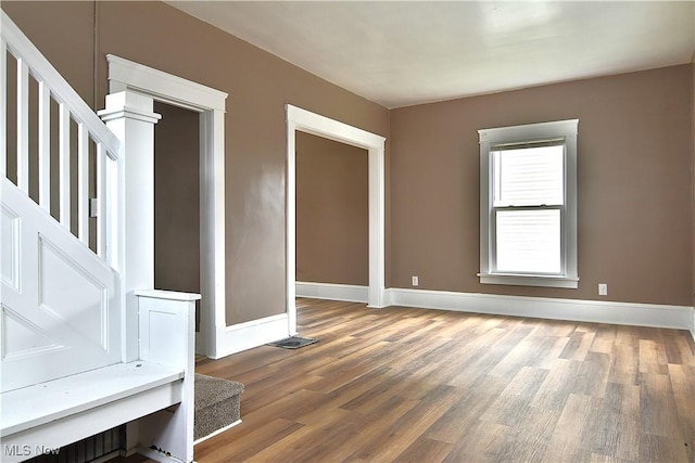 1134 Auburn Pl NW, Canton, OH 44703 - spare room featuring wood finished floors and stairs