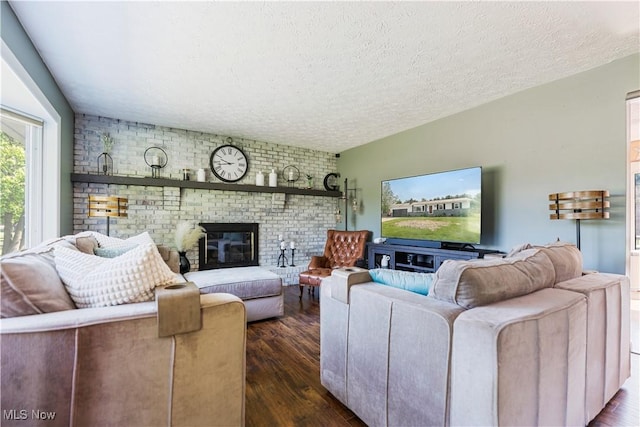 11576 Peach Glen Ave NW, Uniontown, OH 44685 - living area featuring a textured ceiling, dark wood-style floors, and a brick fireplace
