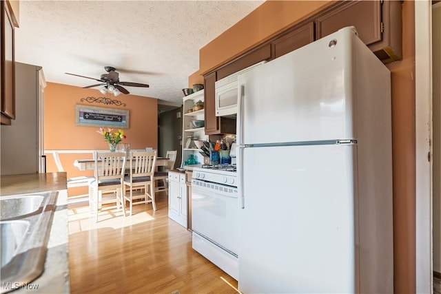 11576 Peach Glen Ave NW, Uniontown, OH 44685 - kitchen with white appliances, a ceiling fan, a textured ceiling, open shelves, and light wood-style floors