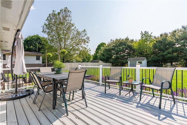 11576 Peach Glen Ave NW, Uniontown, OH 44685 - wooden deck with a shed and outdoor dining area