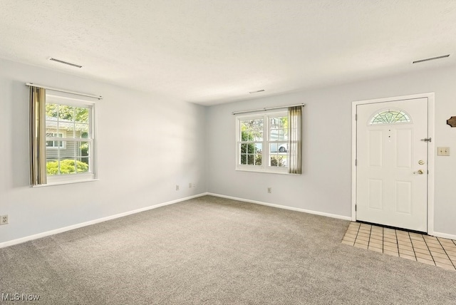 3820 Twin Pines Dr Unit 8A, Uniontown, OH 44685 - carpeted foyer with healthy amount of natural light and a textured ceiling