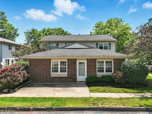 3820 Twin Pines Dr Unit 8A, Uniontown, OH 44685 - view of front of house featuring a patio area, brick siding, and roof with shingles