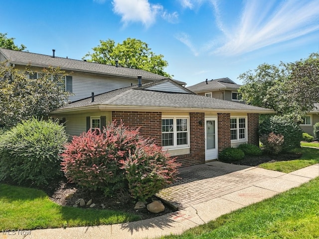 3820 Twin Pines Dr Unit 8A, Uniontown, OH 44685 - traditional home with brick siding, a shingled roof, and a patio