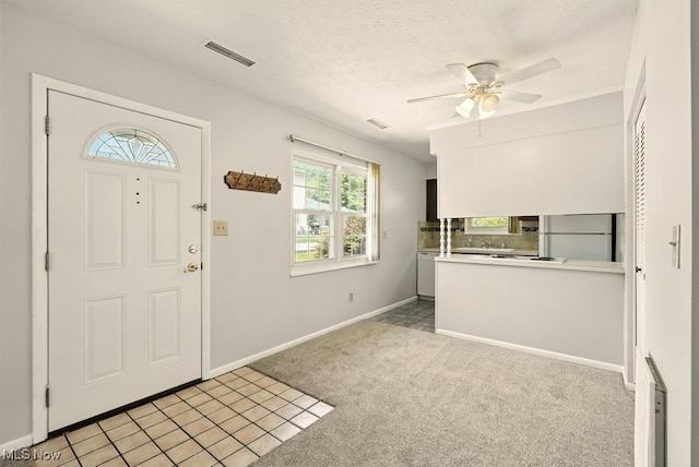 3820 Twin Pines Dr Unit 8A, Uniontown, OH 44685 - foyer entrance with ceiling fan, light carpet, and a textured ceiling