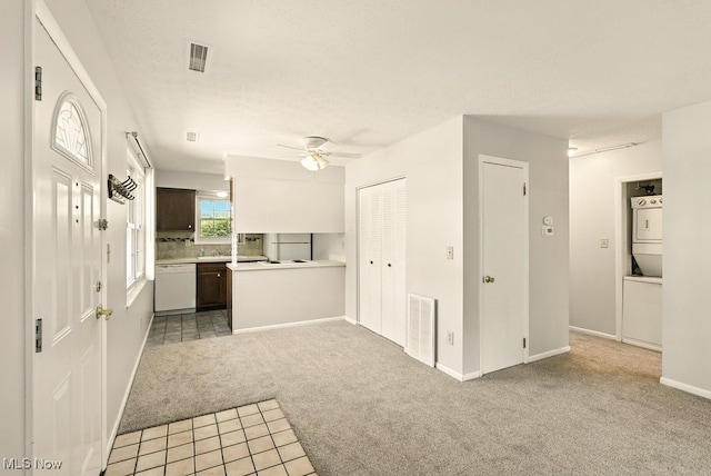 3820 Twin Pines Dr Unit 8A, Uniontown, OH 44685 - unfurnished living room with carpet floors, ceiling fan, tile patterned floors, and a textured ceiling