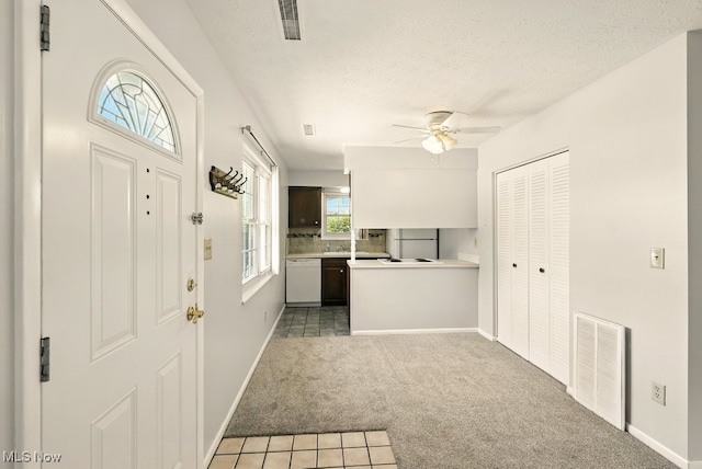 3820 Twin Pines Dr Unit 8A, Uniontown, OH 44685 - entrance foyer with light carpet, a ceiling fan, and a textured ceiling