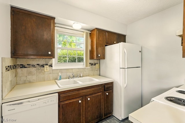 3820 Twin Pines Dr Unit 8A, Uniontown, OH 44685 - kitchen featuring white appliances, light countertops, decorative backsplash, dark brown cabinetry, and a textured ceiling