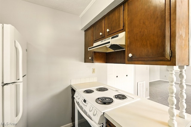 3820 Twin Pines Dr Unit 8A, Uniontown, OH 44685 - kitchen with under cabinet range hood, white appliances, light countertops, dark brown cabinetry, and a textured ceiling