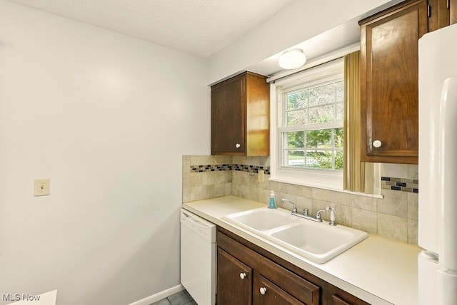 3820 Twin Pines Dr Unit 8A, Uniontown, OH 44685 - kitchen with dishwasher, backsplash, light countertops, fridge, and a textured ceiling