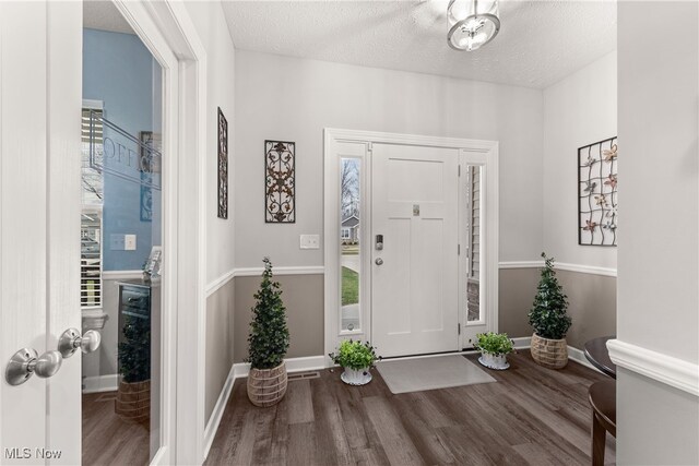 12187 Bexley Dr, Grafton, OH 44044 - foyer entrance featuring wood finished floors and a textured ceiling