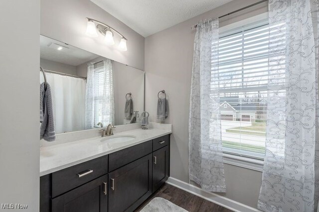 12187 Bexley Dr, Grafton, OH 44044 - full bathroom with plenty of natural light, vanity, and wood finished floors