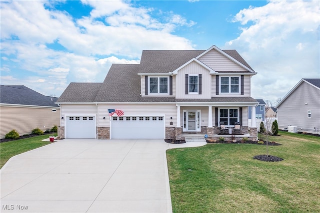 12187 Bexley Dr, Grafton, OH 44044 - craftsman-style home with stone siding, concrete driveway, an attached garage, covered porch, and board and batten siding