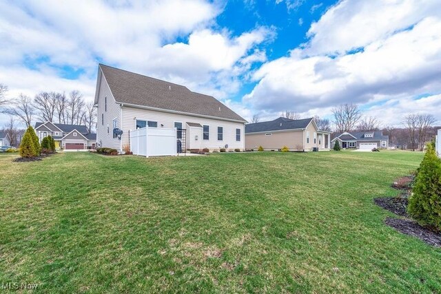 12187 Bexley Dr, Grafton, OH 44044 - back of house with a lawn