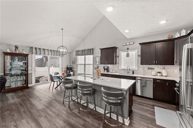 12187 Bexley Dr, Grafton, OH 44044 - kitchen featuring stainless steel appliances, light countertops, dark wood-type flooring, dark brown cabinetry, and recessed lighting