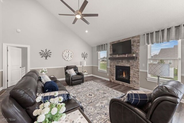 12187 Bexley Dr, Grafton, OH 44044 - living area with ceiling fan, high vaulted ceiling, wood finished floors, and a fireplace