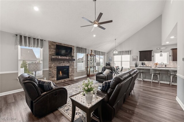 12187 Bexley Dr, Grafton, OH 44044 - living room featuring a ceiling fan, high vaulted ceiling, dark wood-type flooring, recessed lighting, and a fireplace