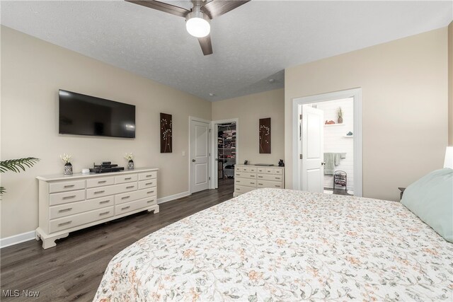 12187 Bexley Dr, Grafton, OH 44044 - bedroom featuring dark wood-type flooring, a spacious closet, a closet, ceiling fan, and a textured ceiling