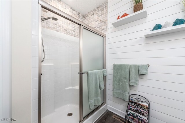 12187 Bexley Dr, Grafton, OH 44044 - bathroom featuring a shower stall and wood finished floors