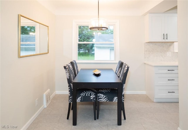 341 Clarmont Rd, Willowick, OH 44095 - dining area with light tile patterned floors and a chandelier