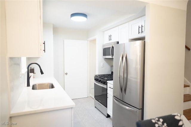 341 Clarmont Rd, Willowick, OH 44095 - kitchen with stainless steel appliances, light countertops, and white cabinetry