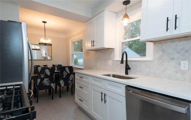 341 Clarmont Rd, Willowick, OH 44095 - kitchen featuring stainless steel appliances, white cabinetry, light countertops, and backsplash