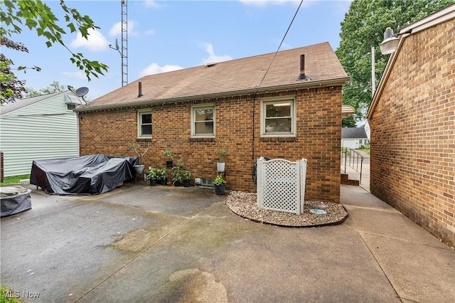 2026 34th St NW, Canton, OH 44709 - rear view of house with brick siding, a patio area, and roof with shingles